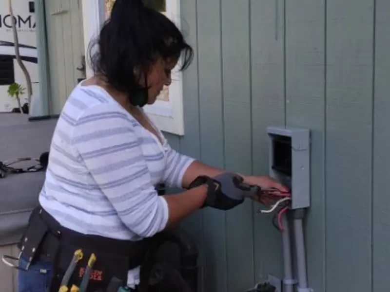 Licensed electrician wiring an exterior subpanel in Spirit Lake