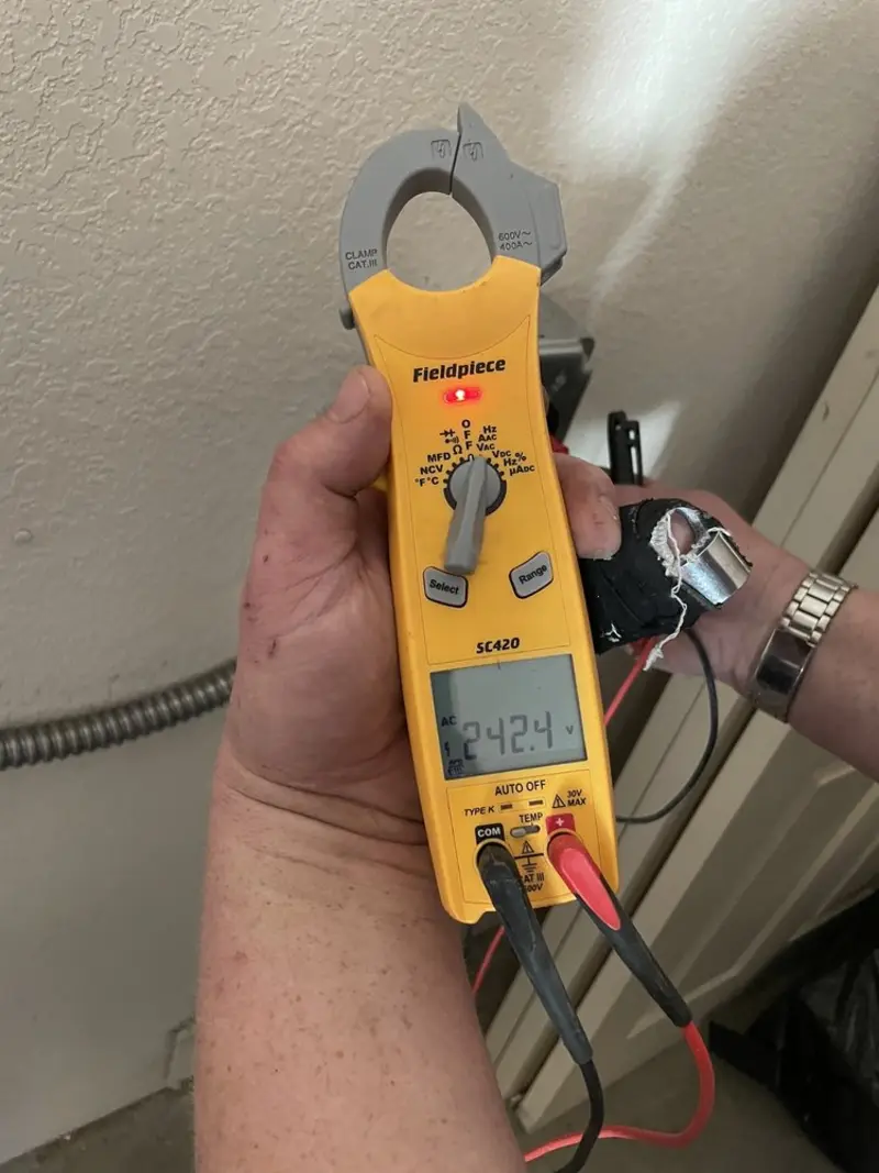 Voltage testing with clamp meter during Whole House Surge Protector in Spirit Lake